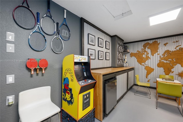 game room featuring finished concrete floors and a bar
