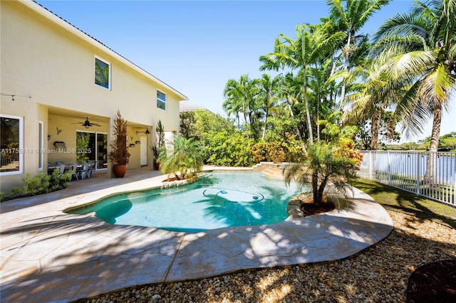 view of pool featuring fence, a patio area, a fenced in pool, and a ceiling fan