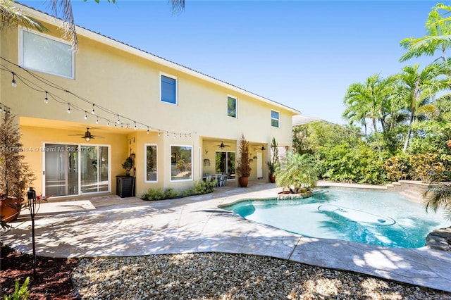 back of house with stucco siding, ceiling fan, an outdoor pool, and a patio