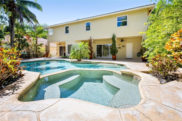 view of swimming pool featuring a patio, a pool with connected hot tub, and a ceiling fan