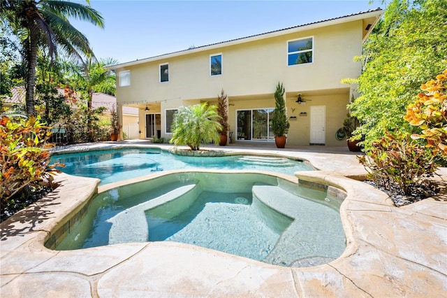 view of swimming pool featuring a ceiling fan, a patio area, and a pool with connected hot tub