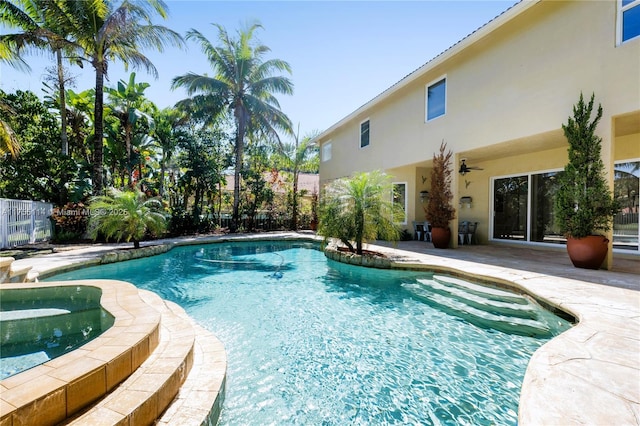 view of swimming pool featuring a patio area, a ceiling fan, fence, a fenced in pool, and an in ground hot tub