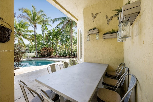 view of swimming pool with a wall mounted AC, a patio, fence, outdoor dining area, and a fenced in pool