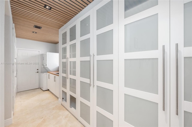 hall with wooden ceiling and light tile patterned floors