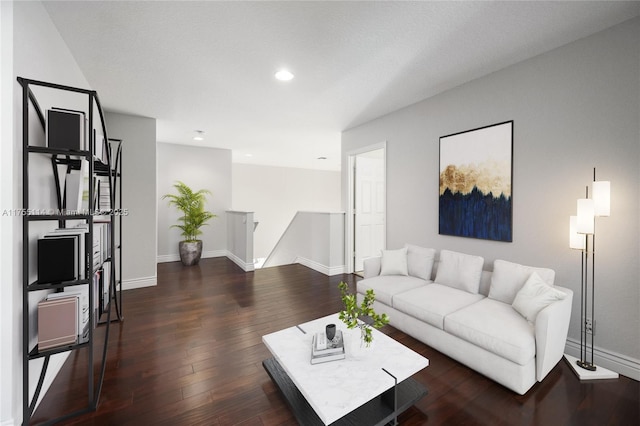 living room with wood finished floors, baseboards, and recessed lighting