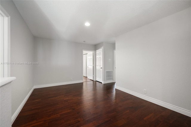 spare room with recessed lighting, wood finished floors, visible vents, and baseboards