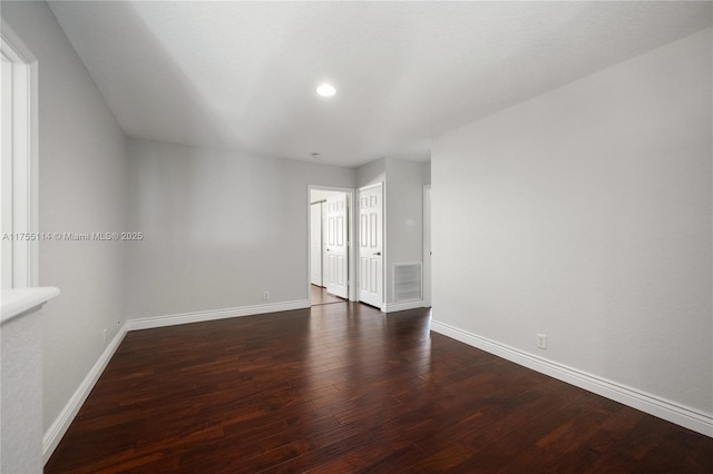 empty room featuring baseboards, wood finished floors, visible vents, and recessed lighting
