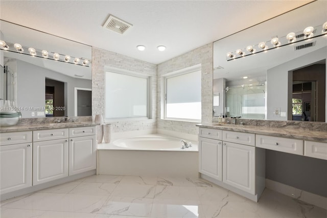 bathroom featuring visible vents, two vanities, marble finish floor, a stall shower, and a bath