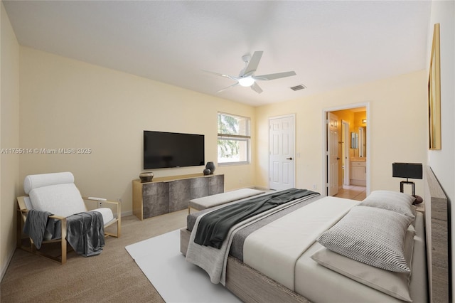 bedroom featuring visible vents, ensuite bath, baseboards, light colored carpet, and ceiling fan