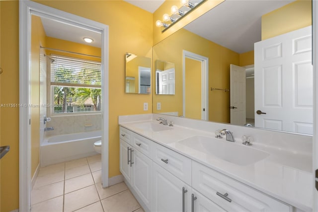 bathroom featuring a sink, toilet, double vanity, and tile patterned floors