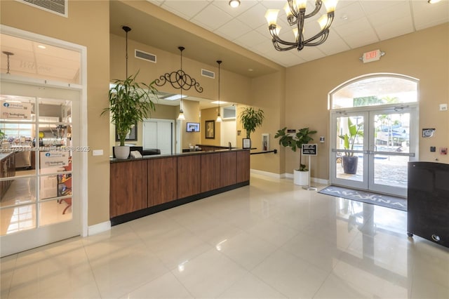 welcome area featuring french doors, a chandelier, and visible vents