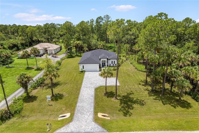 drone / aerial view with a wooded view