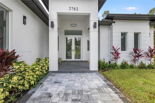 doorway to property with stucco siding and french doors