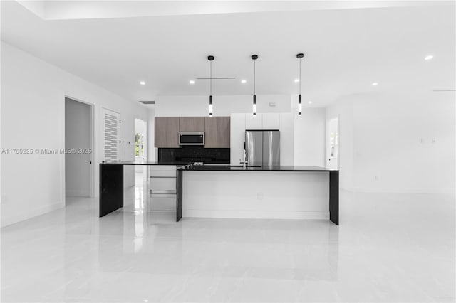 kitchen featuring dark countertops, tasteful backsplash, recessed lighting, stainless steel appliances, and modern cabinets