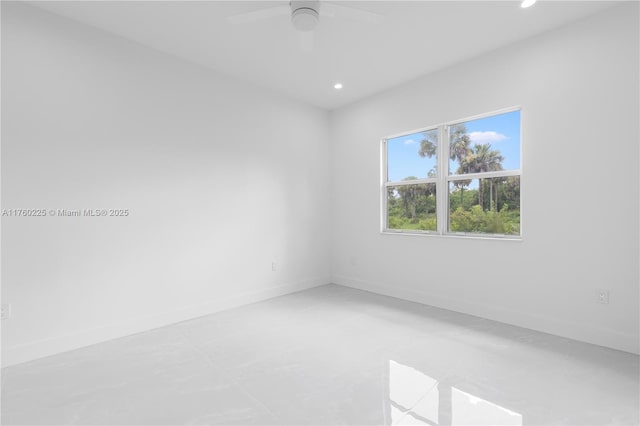 empty room with recessed lighting, a ceiling fan, and baseboards