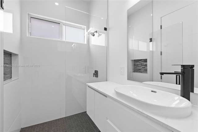 bathroom featuring walk in shower and vanity