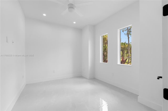 empty room with recessed lighting, concrete floors, baseboards, and ceiling fan