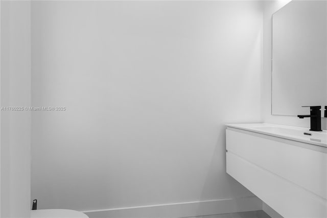 bathroom featuring vanity and baseboards