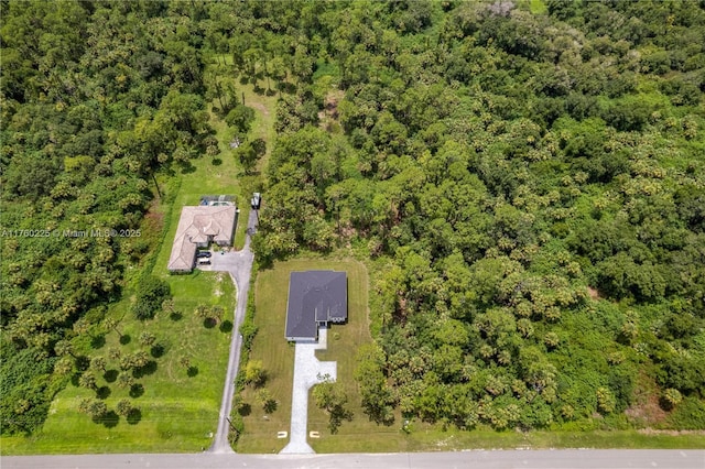 drone / aerial view featuring a forest view