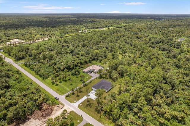 drone / aerial view featuring a view of trees