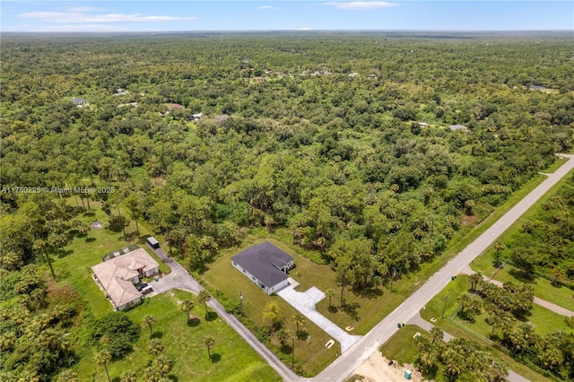 drone / aerial view featuring a forest view