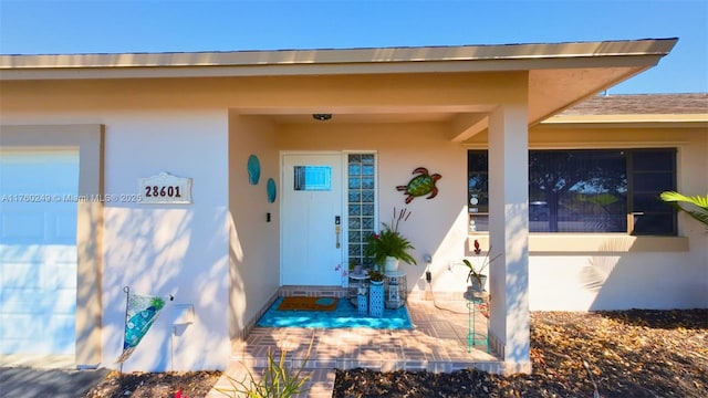 view of exterior entry featuring stucco siding