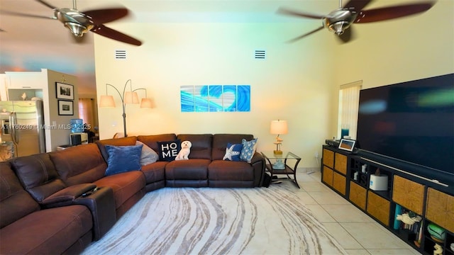 living area featuring tile patterned flooring, visible vents, and ceiling fan