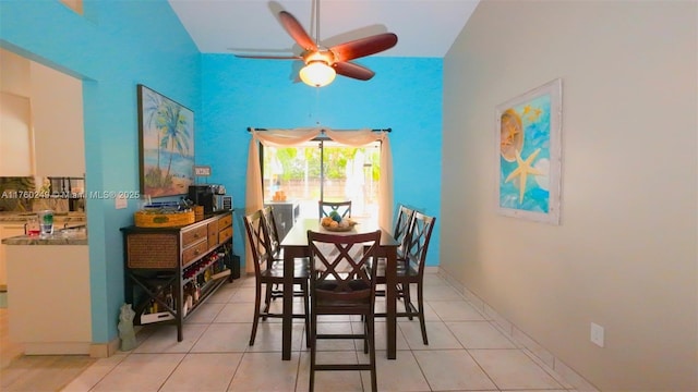 dining room with light tile patterned floors, a ceiling fan, and baseboards