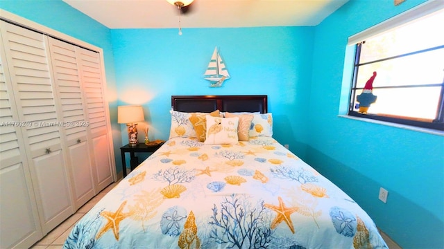 bedroom featuring tile patterned flooring and a closet