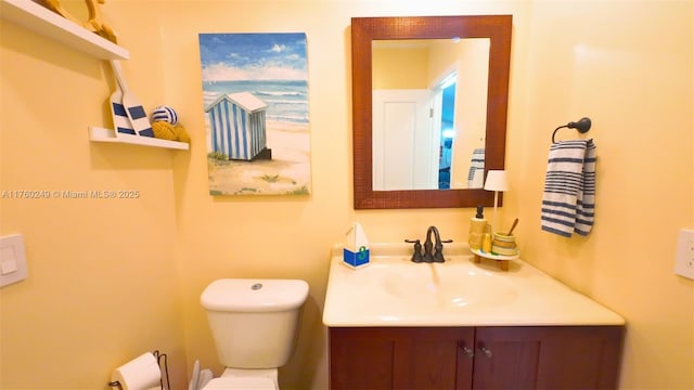 bathroom featuring toilet and vanity