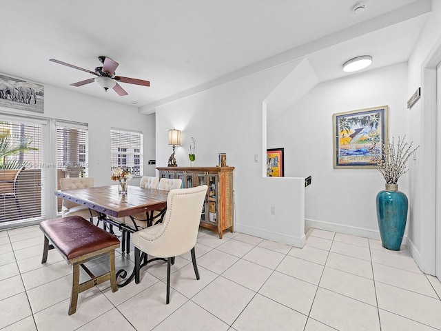 dining area with light tile patterned floors, ceiling fan, and baseboards