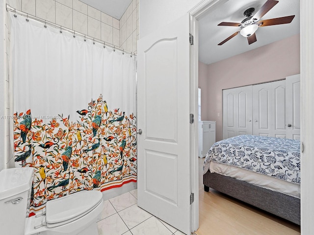 bedroom with light tile patterned floors, a closet, and ceiling fan