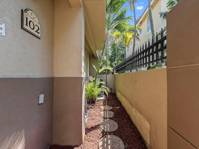 view of home's exterior featuring stucco siding and fence