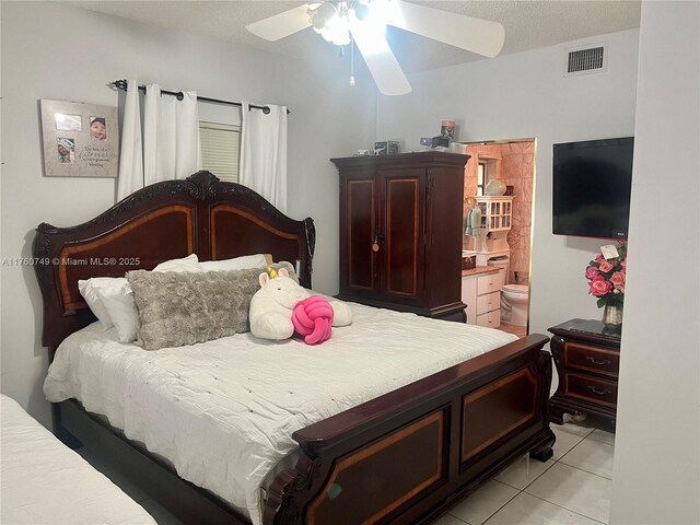 329 Minola Dr, Miami Springs, FL 33166 - bedroom with visible vents, connected bathroom, light tile patterned flooring, a textured ceiling, and a ceiling fan
