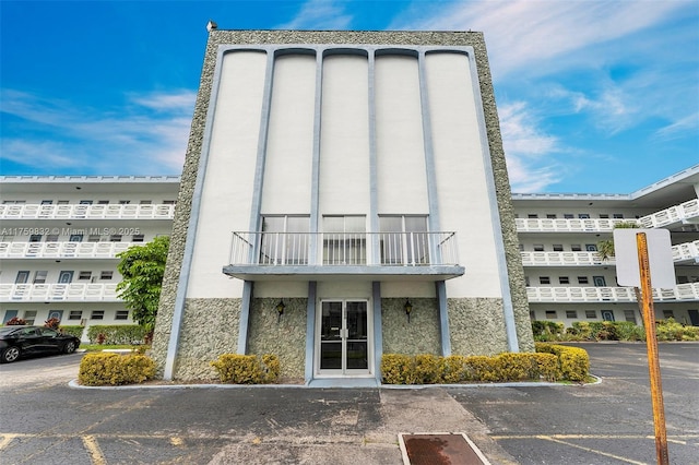 view of building exterior featuring uncovered parking