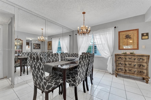 dining room with a chandelier, a textured ceiling, and light tile patterned flooring