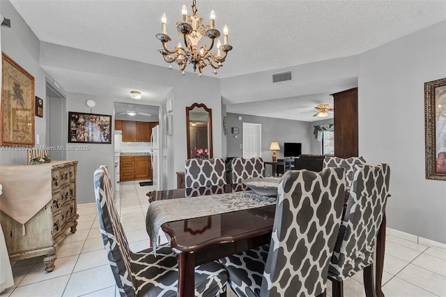 dining room with ceiling fan, light tile patterned flooring, visible vents, and a textured ceiling