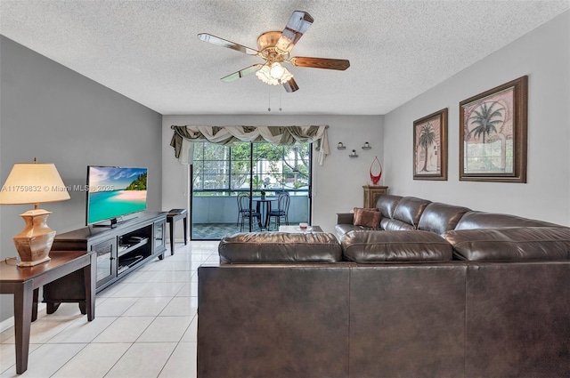 living area featuring light tile patterned floors, a textured ceiling, and a ceiling fan