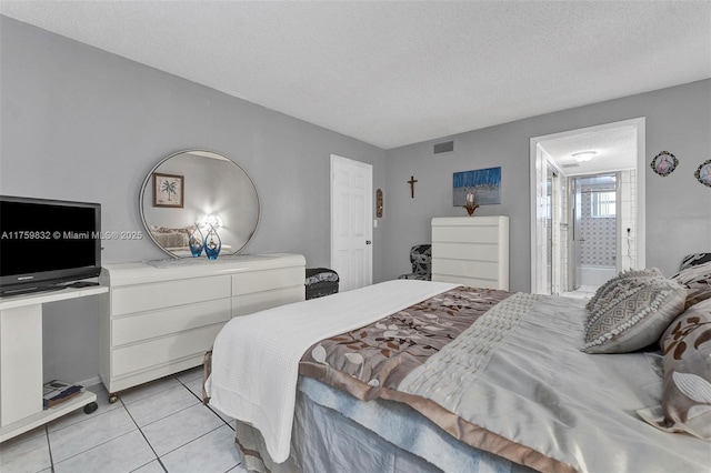 bedroom with light tile patterned floors, visible vents, and a textured ceiling