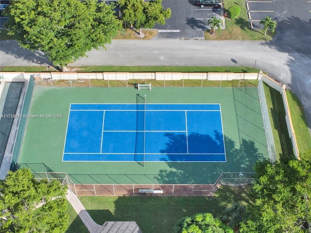 view of tennis court featuring fence