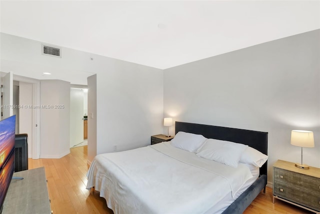 bedroom with light wood-style flooring and visible vents