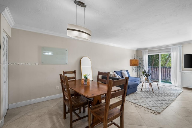 dining space featuring light tile patterned floors, a textured ceiling, and crown molding