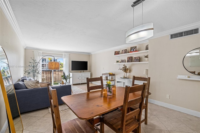 dining room featuring visible vents, ornamental molding, a textured ceiling, light tile patterned floors, and baseboards