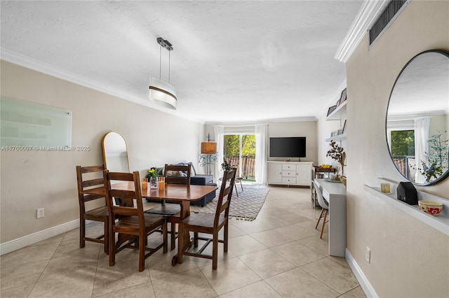 dining room featuring visible vents, baseboards, ornamental molding, and light tile patterned flooring