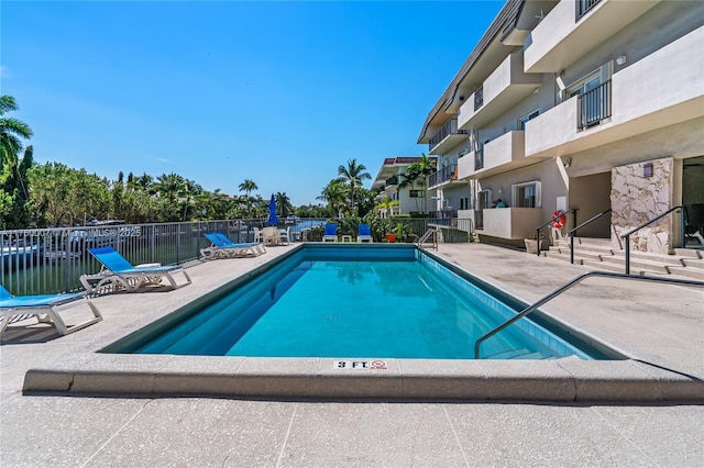 pool featuring a patio area and fence