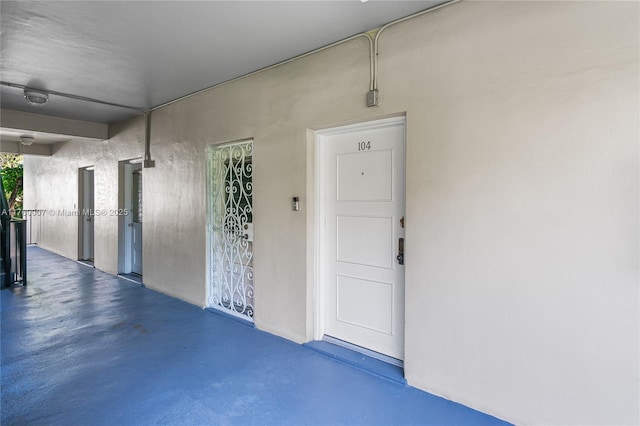 doorway to property featuring stucco siding