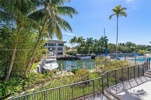 view of water feature featuring a boat dock and fence