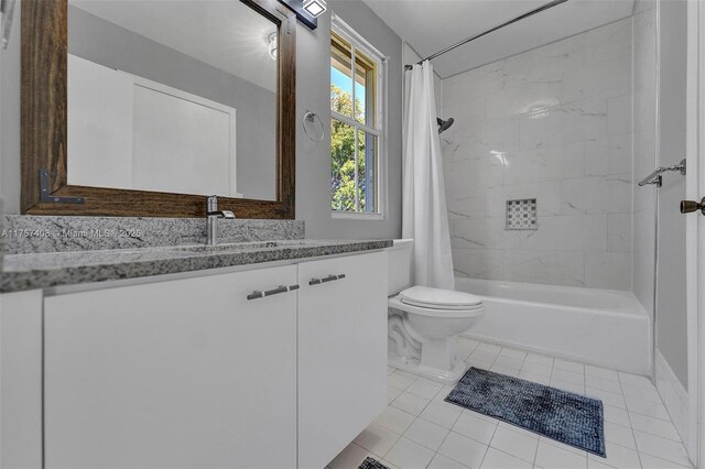 full bathroom featuring tile patterned floors, toilet, vanity, and shower / bath combo