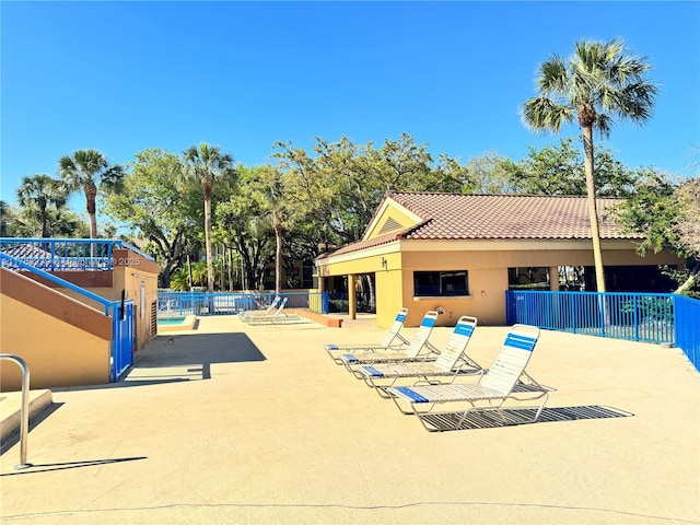 view of pool featuring a patio and fence