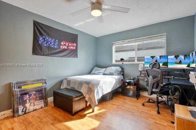 bedroom featuring a ceiling fan and wood finished floors